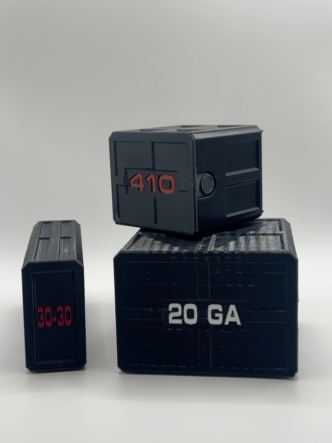 Three black 3D printed ammunition cases