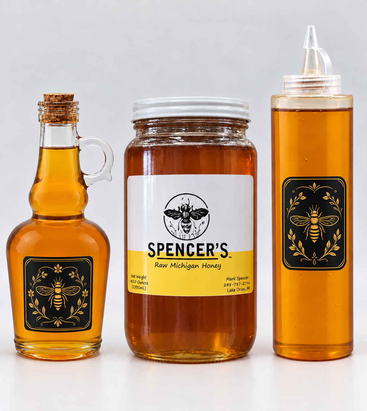 A 13.5 ounce glass cork bottle, a 45 ounce jar of Spencer's honey, and a 20 ounce squeeze bottle
